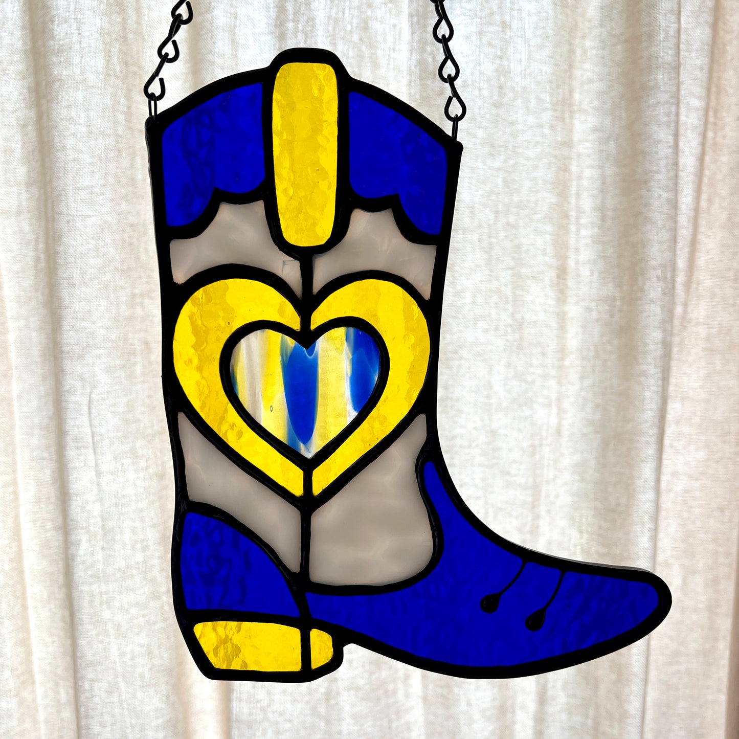 Backlit Blue and yellow stained glass cowboy boot